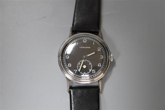 A gentlemans 1950s/1960s? steel Longines black dial manual wind wrist watch, on associated strap.